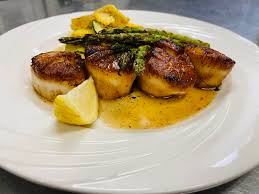 Henry’s Salt of the Sea signature dishes Escargots de Bourgogne, Pan-Seared Sea Scallops, Lobster, Dover Sole Meunière